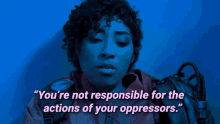 a woman in a red jacket with the words " you 're not responsible for the actions of your oppressors " on the bottom