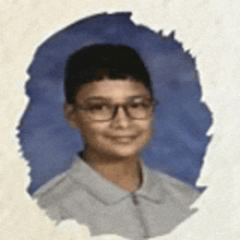 a young boy wearing glasses and a white shirt is smiling for a school photo .