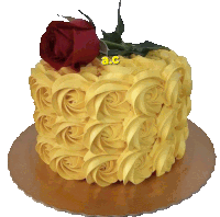 a cake with yellow frosting and a red rose on top has a c on it