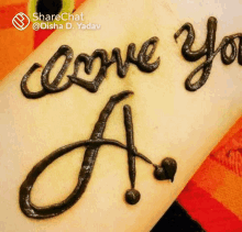 the word love is written in henna on a person 's wrist