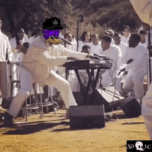 a man wearing a purple hat with a marijuana leaf on it is playing a keyboard in front of a crowd