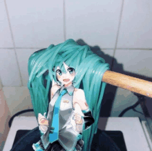 a figurine of hatsune miku is holding a wooden stick with noodles on it