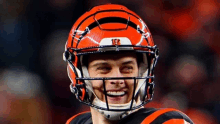 a smiling football player wearing a helmet with the number 15 on it