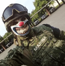 a soldier wearing a clown face and a vest that says marina