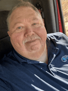 a man wearing a blue shirt that says blue ribbon