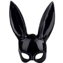 a black bunny mask with large ears and a black eye