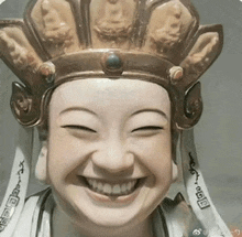 a statue of a person wearing a crown is smiling