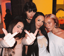 a group of women giving the middle finger to the camera