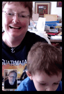 a woman wearing a shirt that says guatemala talks to a child