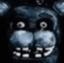 a close up of a teddy bear 's face in the dark with glowing eyes .