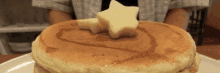 a close up of a pancake with syrup and a star of butter on top