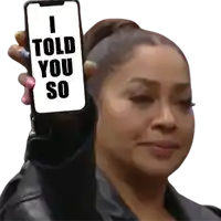 a woman holds up a cell phone that says i told you so