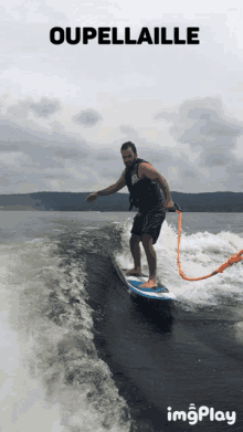 a man is riding a wave on a surfboard with the words oupellaille behind him