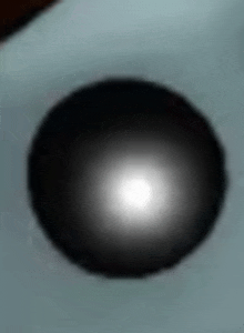 a close up of a black circle with a white light in the middle .