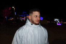 a man wearing a white jacket with a hood