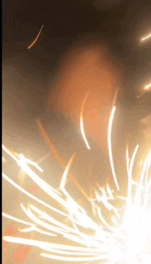 a blurred image of a fireworks display with sparks coming out of it