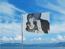 a flag with a picture of a man and a woman flying in the wind