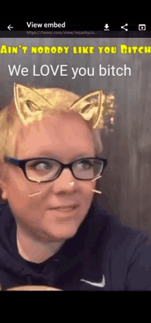 a woman wearing glasses and cat ears says we love you bitch on a phone screen