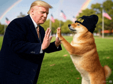 donald trump giving a high five to a dog that is wearing a beanie that says usa