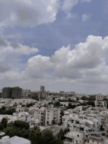 an aerial view of a city with a cloudy sky in the background