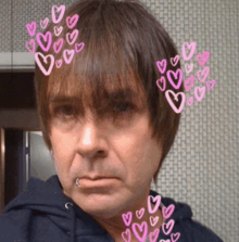 a close up of a man 's face with hearts drawn on his hair