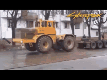 a yellow tractor is driving down a street with the words cyberpunk written on the side