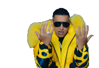 a man wearing a yellow jacket and sunglasses is covering his face