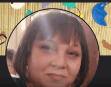 a close up of a woman 's face in a circle on a bamboo mat