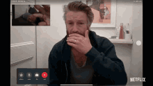 a man is on a video call with a netflix app open