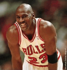 a basketball player wearing a bulls jersey smiles for the camera