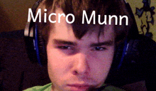 a young man wearing headphones has the name micro munn written on his forehead