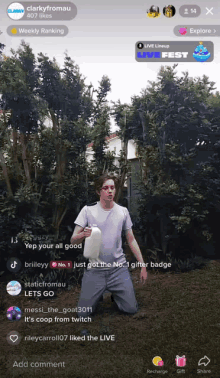 a man is kneeling down holding a bottle in front of trees and a live fest logo