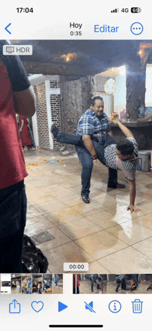 a phone screen shows a man carrying another man on his back