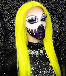 a woman with yellow hair and purple makeup is wearing a black top