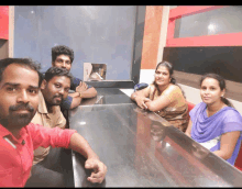 a group of people sitting at a table with their arms folded