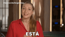 a woman in a red shirt with the word esta written on her chest