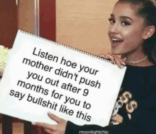 a woman is holding a sign that says listen hoe your mother did n't push you out after 9 months for you to say bullshit