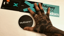 a hand is holding a sticker that says multiverse