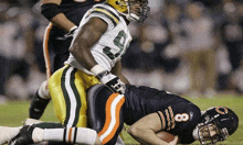 a football player with the number 8 on his helmet is laying on the ground