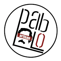 a logo for pab lo artisan is shown in a circle