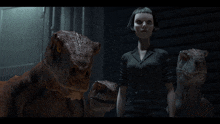 a woman in a black suit stands next to three dinosaurs