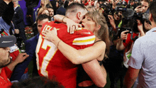 a woman hugging a man in a red jersey with the number 7 on it