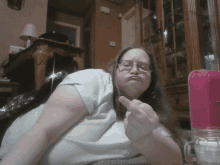 a woman wearing glasses giving the middle finger