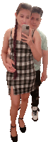 a woman in a plaid dress is taking a picture of herself with her phone