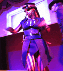 a woman wearing a top hat and striped pants is dancing