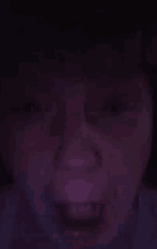 a close up of a person 's face in the dark .