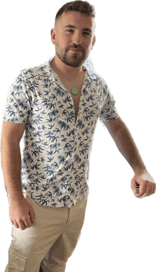 a man with a beard wearing a white shirt with palm trees on it