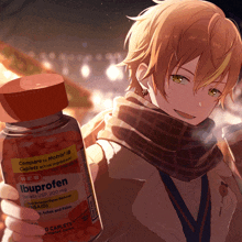 a boy is holding a bottle of ibuprofen in his hand