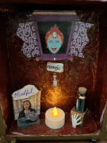 a display with a candle and a sign that says magic