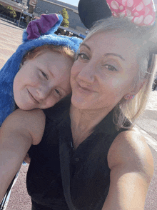 a woman and a child wearing mickey mouse ears